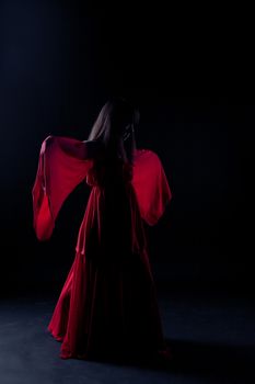 Young girl dancer in a darkness before start
