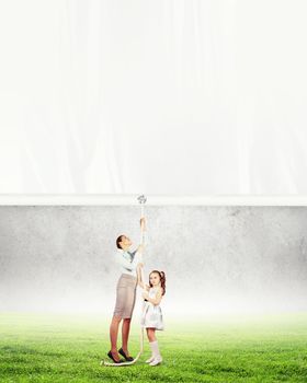 Woman and little girl pulling banner. Place for text