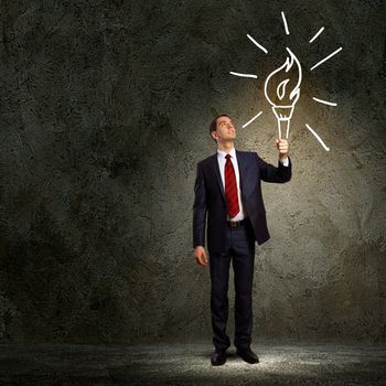 Image of businessman in black suit against dark background