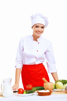 Young cook preparing food wearing a red apron