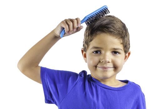 An young boy brushing his hair isolated on a white background.
