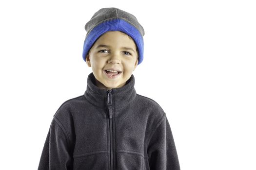 A young boy dressed in winter clothing isolated on a white background.