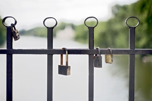 Wedding ritual spouses - as a sign of eternal fidelity to each other on their wedding day hanging locks on the bridge over the river in Krivoy Rog in Ukraine