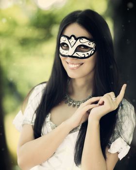 Portrait of a young woman with a Venetian mask.