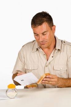 Guy setting up a sandwich stuffed with bills, a financial concept