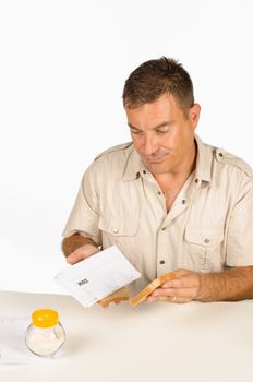 Guy setting up a sandwich stuffed with bills, a financial concept