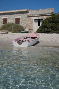 Boat on a  beach of Santa Maria, an island of the La Maddalena archipelago in Sardinia, Italy