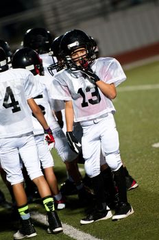 Young football boy looking at the coach.