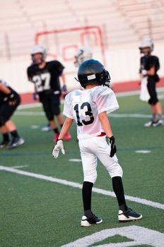 Youth football player on defense