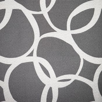 Abstract pattern of interlocking irregular white circles on a grey lived background