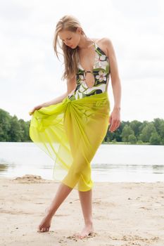 Beautifull model in bikini on the beach with sunny weather