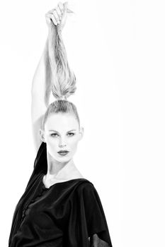 Beautifull young blond woman in the studio holding up her hair