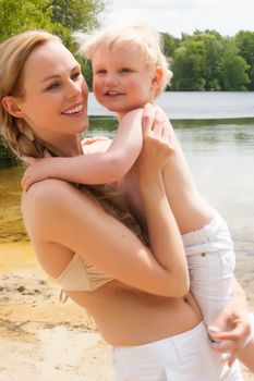 Happy mother and son having a nice day at the beach