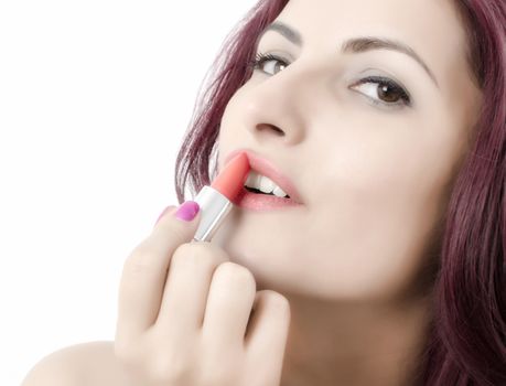 Close up of a young women applying lipstick