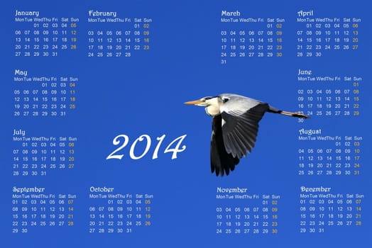 2014 english calendar with great heron flying across a deep blue sky by sunrise
