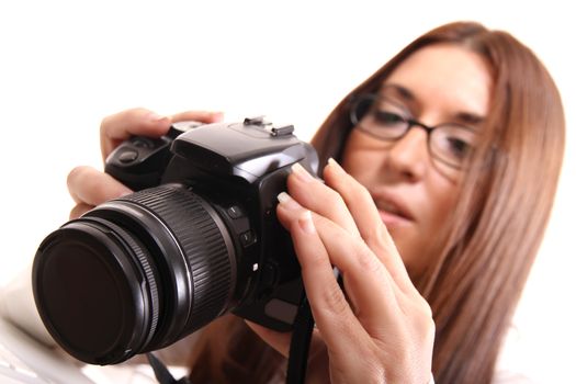 A young hispanic woman checking the Images on a digital camera.