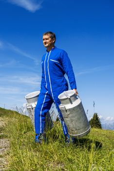 Herdsman standing in front of cattle in farm