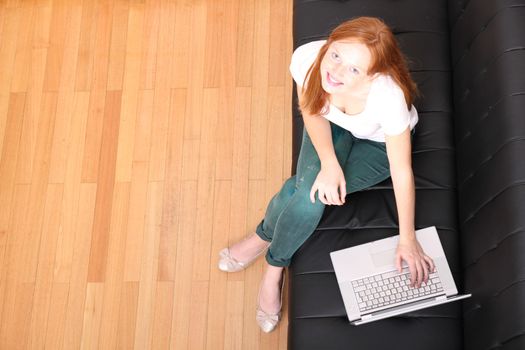 A young, brazilian woman surfing on the Internet with a Laptop.  