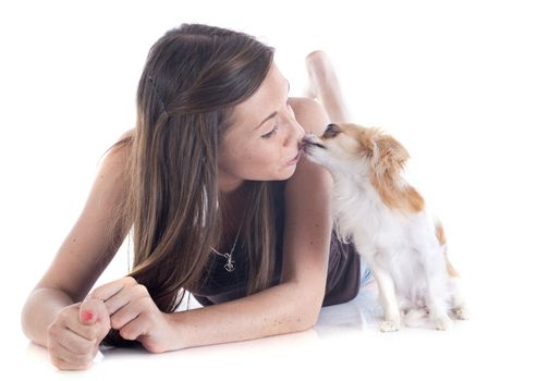 young girl and chihuahua in front of white background