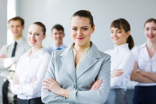 Young business people standing with arms crossed on chest