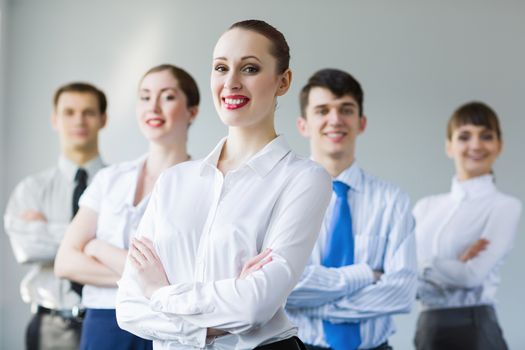 Young smiling businesswoman with colleagues. Leadership concept