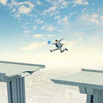 Businessman jumping over a gap in the bridge as a symbol of bridge