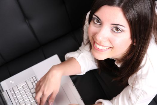 A young woman surfing on the Internet with a Laptop.  