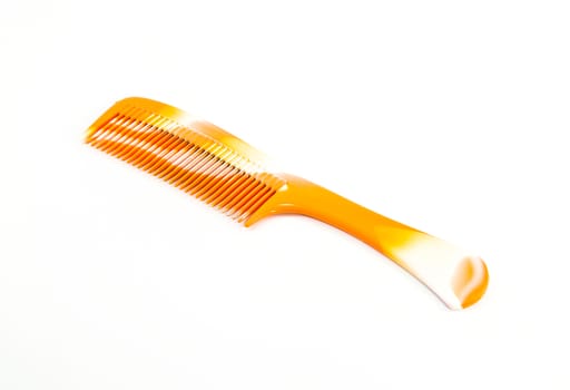 Orange comb for hair; isolated on white background