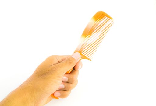 Orange comb in hand isolated on white background