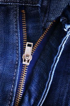 Zipper of blue jeans close up