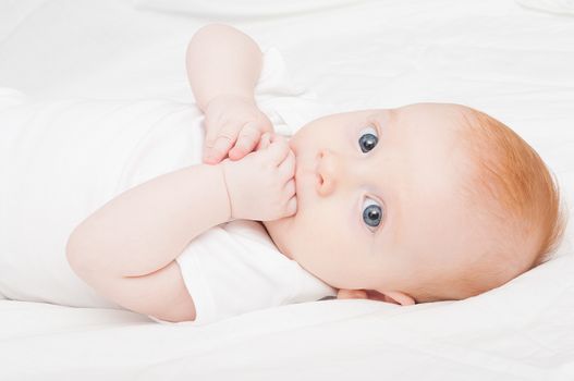Cute Baby Girl Sucking Her Fingers on White Background