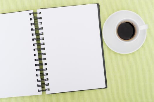 Closeup of Blank Diary and Cup of Coffee on Table