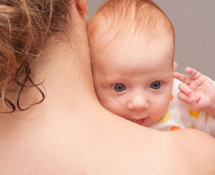 Mother from Behind Holding  Newborn Baby