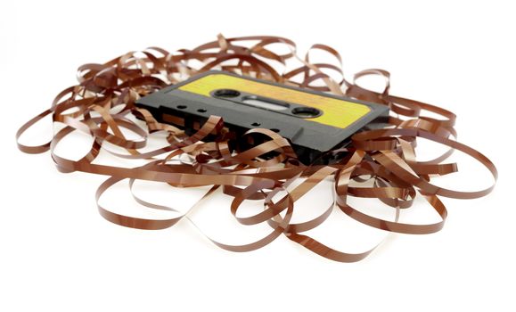 Retro Audio Cassette Tape With Pulled Out Tape on White Background - Shallow Depth of Field - Focus on Pulled Out Tape