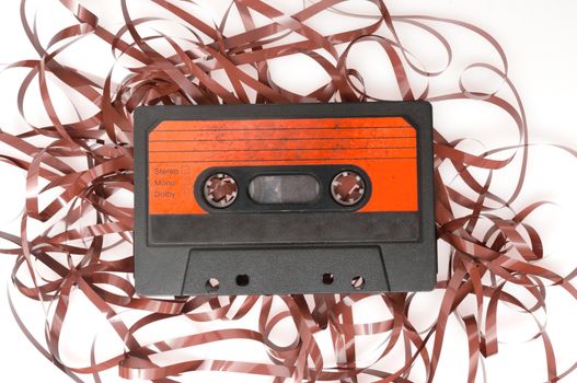 Retro Audio Cassette Tape With Pulled Out Tape on White Background