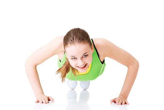 Fitness woman doing push ups , isolated on white background