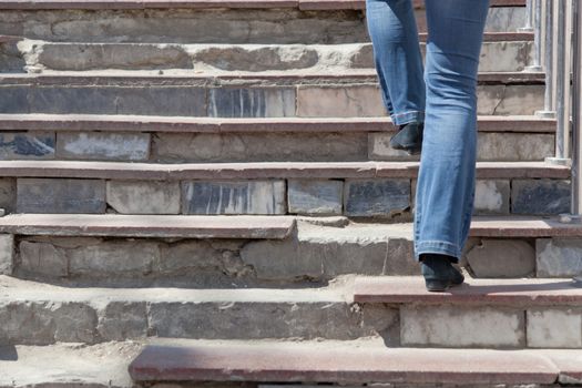 woman rises up on the destroyed steps