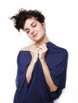 Young woman in blue t-shirt hugging herself