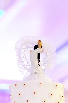 Wedding couple doll on top of wedding cake
