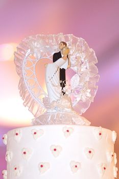 Wedding couple doll on top of wedding cake