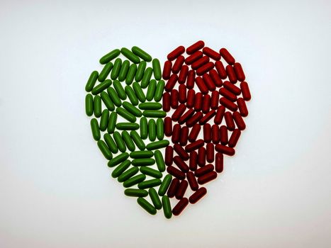 As a dietary supplement tablets arranged in a heart shape divided into red and green