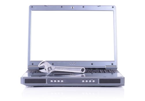 concept of it support with a spanner on a laptop, screen white copy space and isolated on white