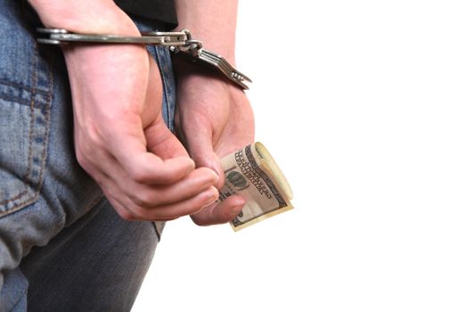 Handcuffs on the Hands with a Money Closeup Isolated on the White Background