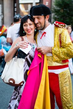 KIEV, UKRAINE - JUL 1: Spanish football fan in toreador costume is photographed with Ukrainian girl before EURO 2012 final match Spain vs. Italy on July 1, 2012 in Kiev, Ukraine