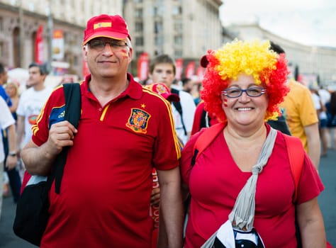 KIEV, UKRAINE - JUL 1: Couple of mature Spanish football fans go to EURO 2012 final match Spain vs. Italy on July 1, 2012 in Kiev, Ukraine