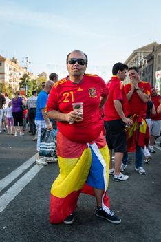 KIEV, UKRAINE - JUL 1: Spanish football fan drink beer on the central fun zone before EURO 2012 final match Spain vs. Italy on July 1, 2012 in Kiev, Ukraine