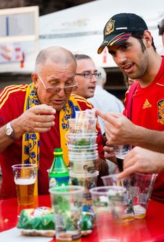 KIEV, UKRAINE - JUL 1: Spanish and Ukrainian football fans drink beer before final match EURO 2012 Spain vs. Italy on July 1, 2012 in Kiev, Ukraine