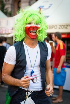 KIEV, UKRAINE - JUL 1: Joyful Italian football fan goes to EURO 2012 final match Spain vs. Italy on July 1, 2012 in Kiev, Ukraine