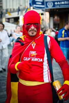 KIEV, UKRAINE - JUL 1: Spanish football fan with superman costume goes to EURO 2012 final match Spain vs. Italy on July 1, 2012 in Kiev, Ukraine