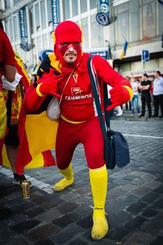 KIEV, UKRAINE - JUL 1: Spanish football fan with superman costume goes to EURO 2012 final match Spain vs. Italy on July 1, 2012 in Kiev, Ukraine